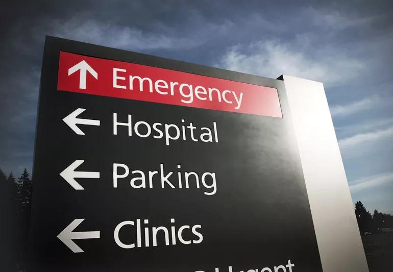A closeup of a hospital emergency sign.