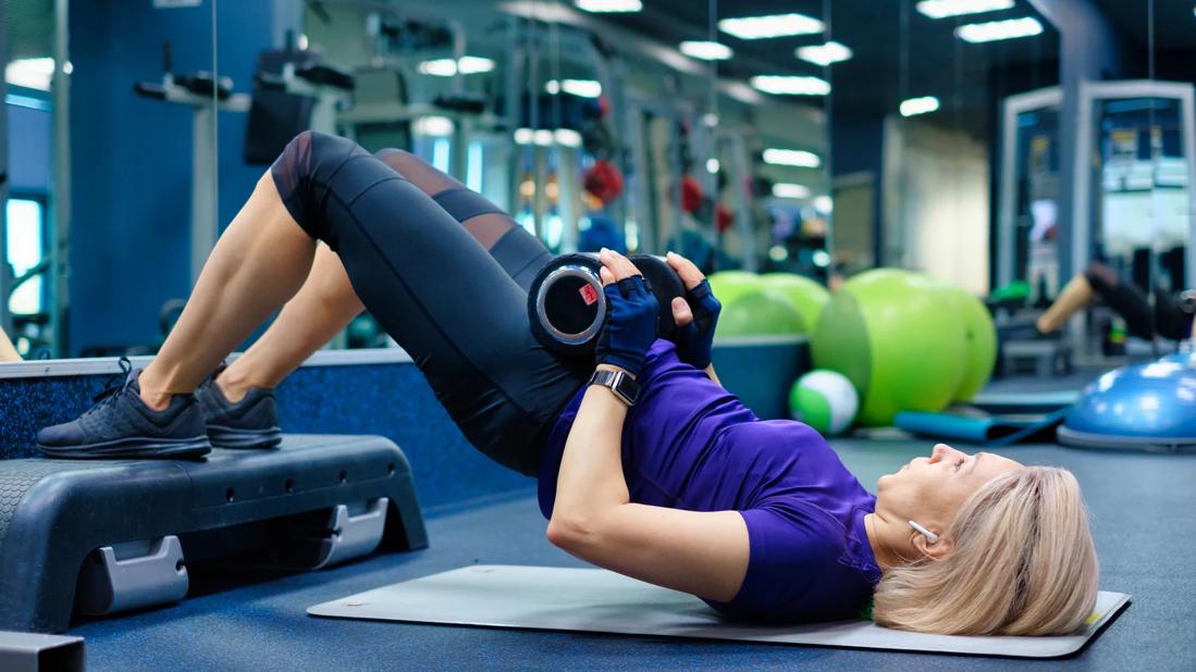 Person doing hip thrust exercise for glute exercise at the gym