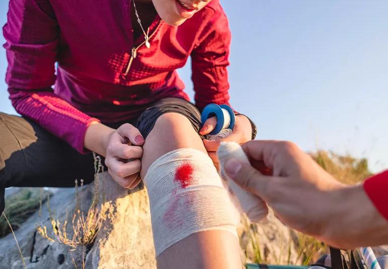 biker needs first aid on leg cut wounded