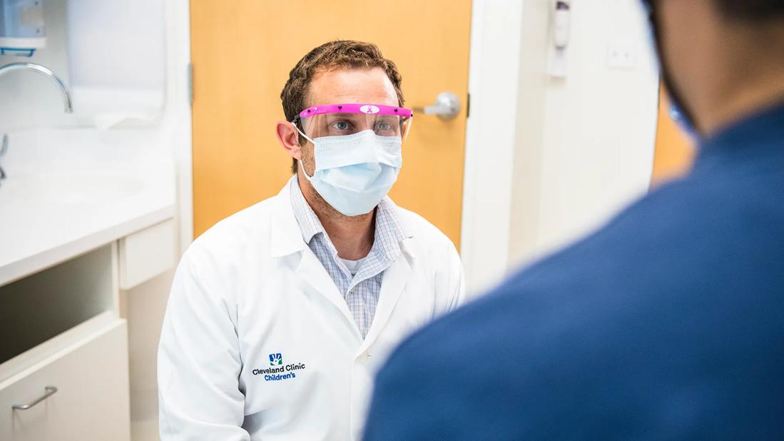 Dr. Rotz sits with a patient