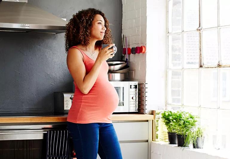 pregnant woman drinking coffee