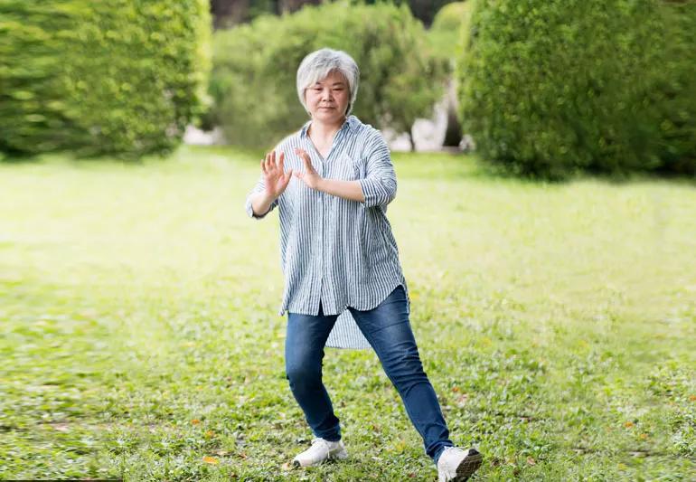 woman practicing Qi Gong in park