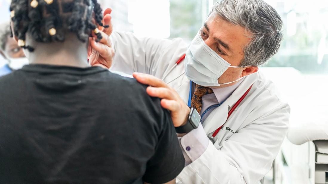 Dr. Hanna gives patient a clinical exam