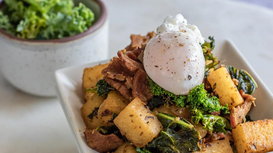 Plate of jicama hash with kale and poached egg