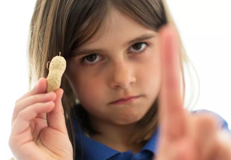 upset girl holding peanut