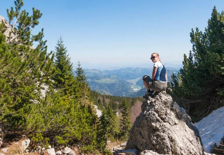 woman on vacation climbing rocks in mountains