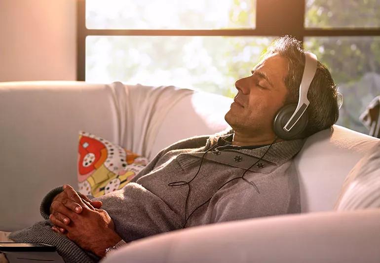 Man relaxing listening to music on couch