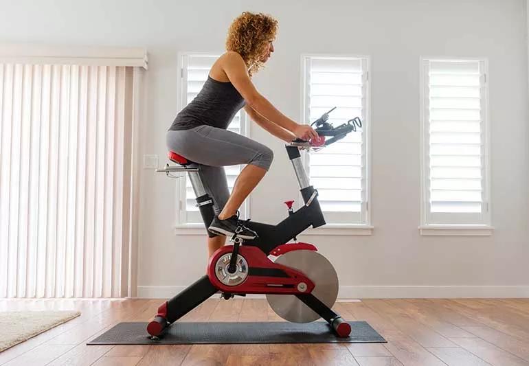 person on indoor cycle bike