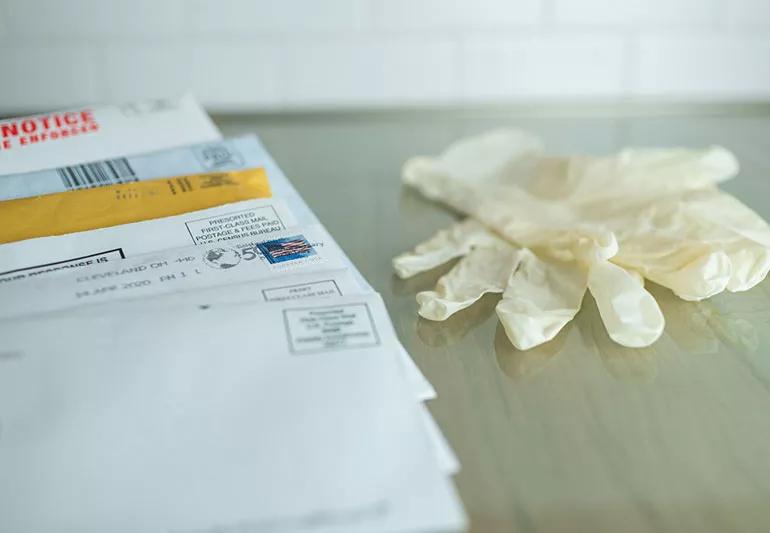 mail next to rubber gloves