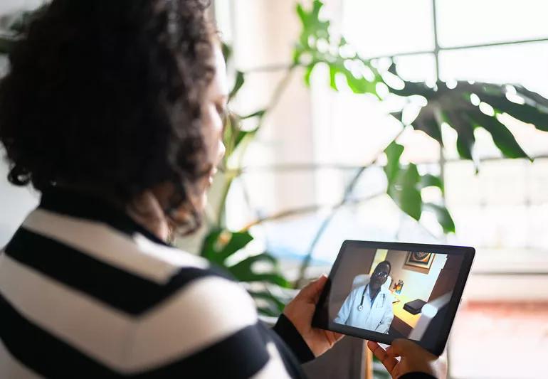 A person on a virtual call with a doctor.