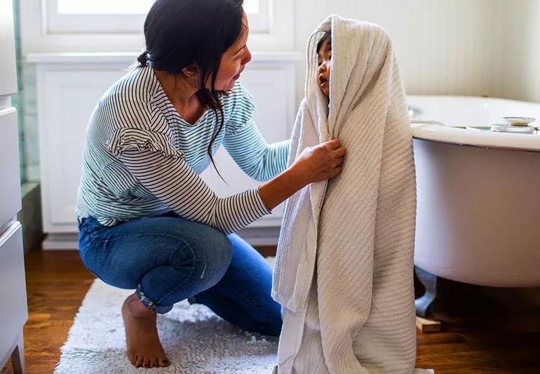 Mother drying her child with towel