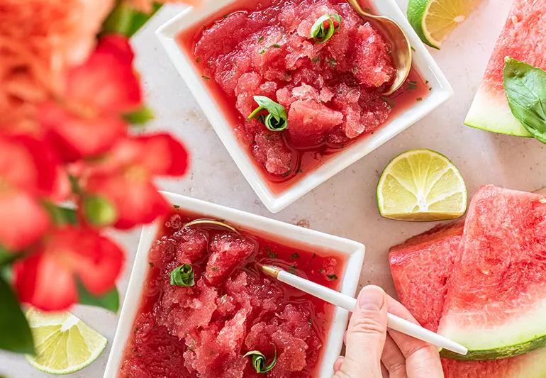 Bowls of watermelon granita with basil that look like a dark-pink icy slush