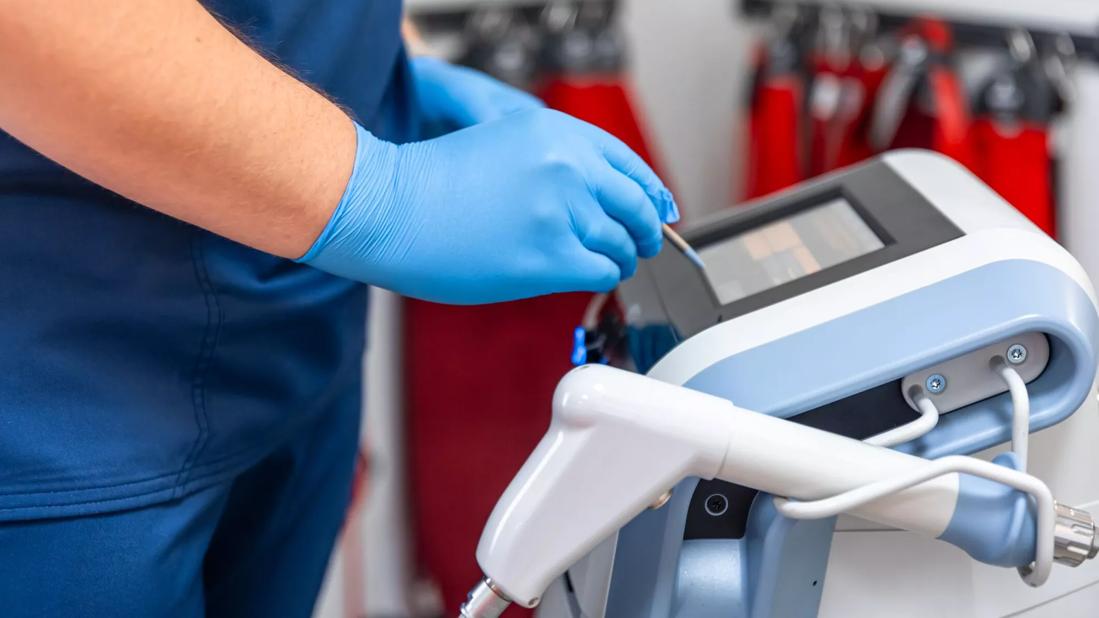 Healthcare provider using a shockwave therapy machine