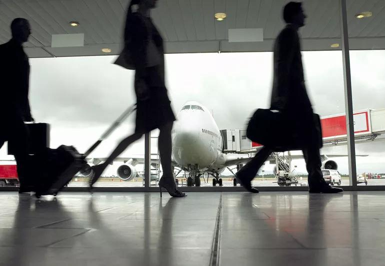 people rushing to their flights at an airport