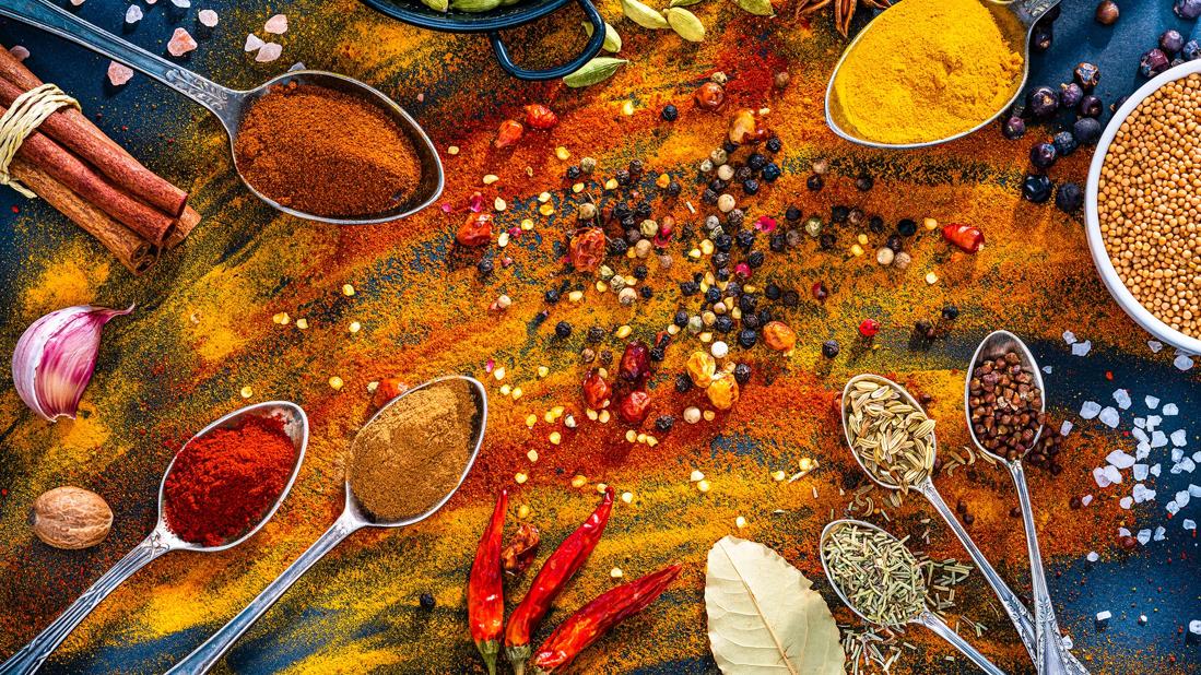 Various herbs and spices like paprika, tumeric, bay leaf, rosemary, cumin and peppercorns