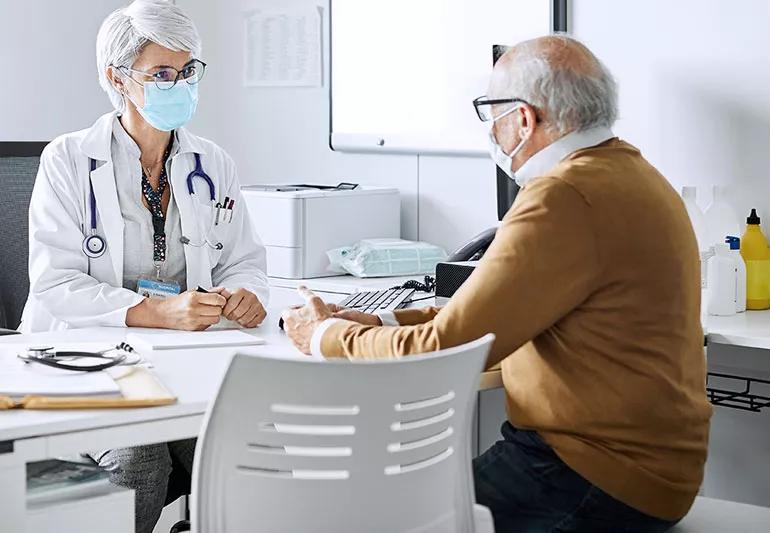 Patient talks to physician regarding symptoms of cancer diagnosis.