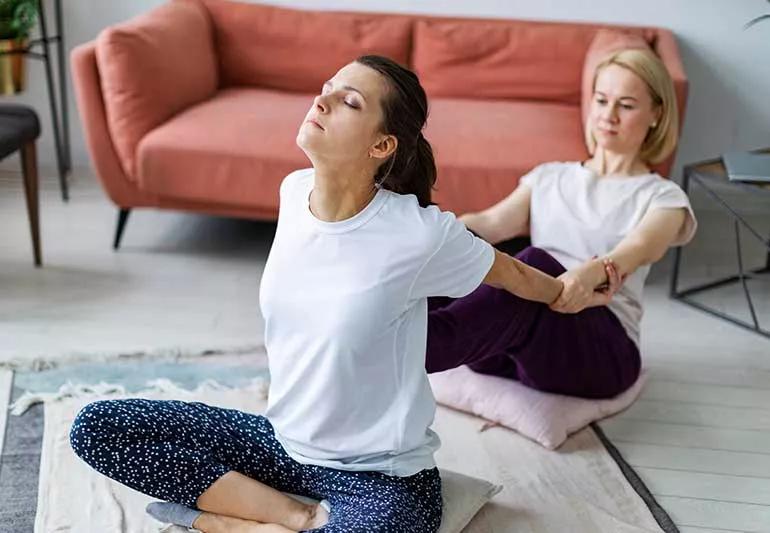 2 people practicing thai massage