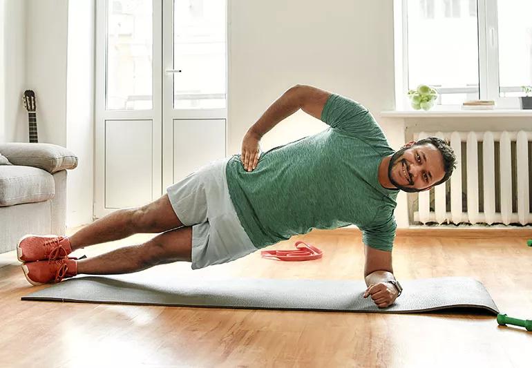 man performing side plank to strengthen back