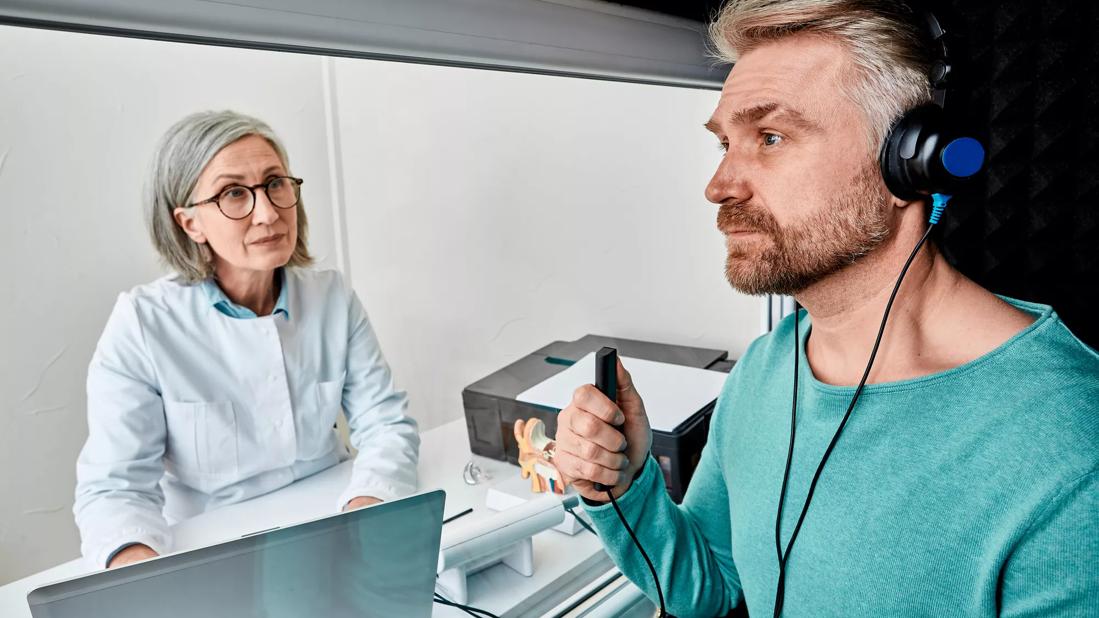 Person getting an audiogram, with technician