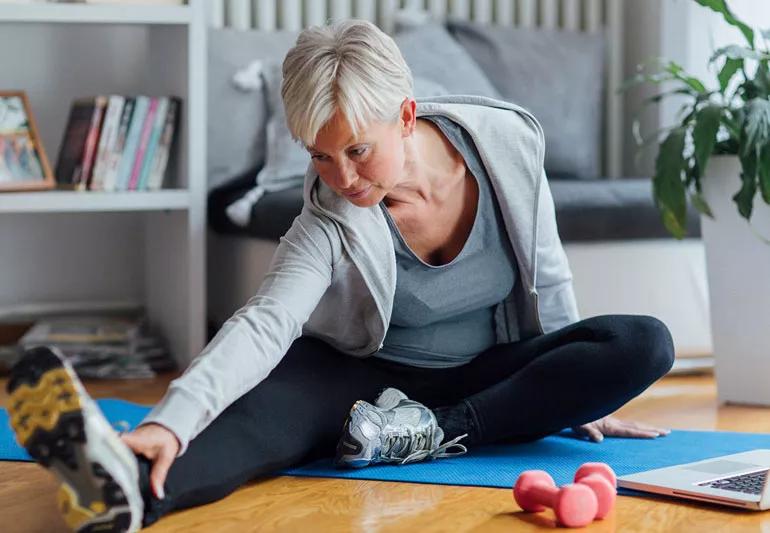 Older woman stretching and exercising to stave off osteoarthritis