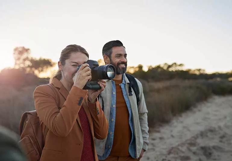 Woman and man taking pictures.