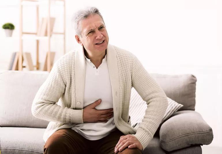 Older man with digestive discomfort