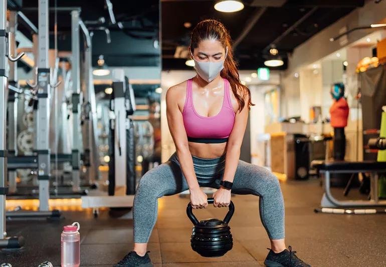 woman exercising while wearing a face mask
