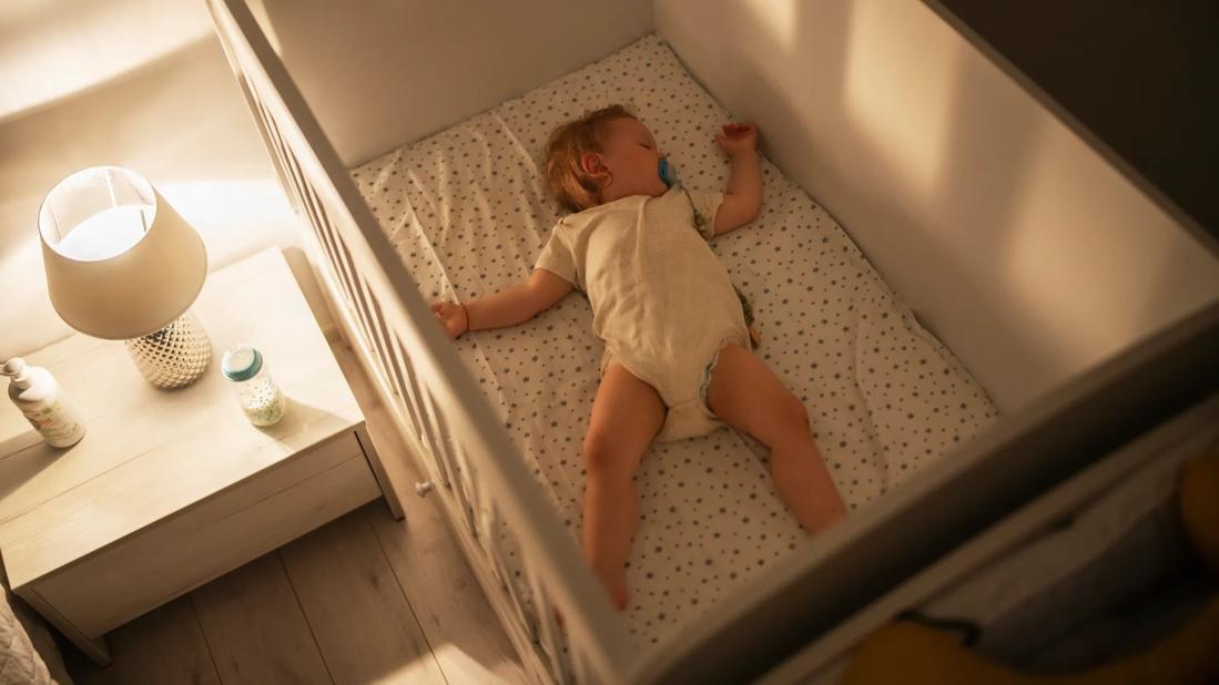 Baby sleeping on their back in crib