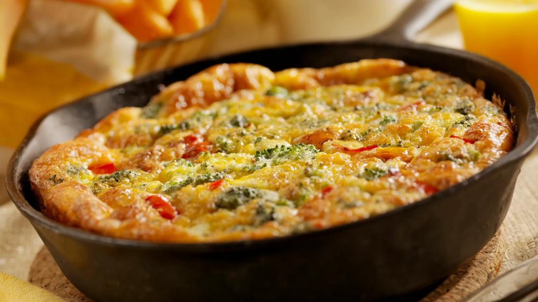 Vegetable frittata in iron skillet, with sweet potato fries