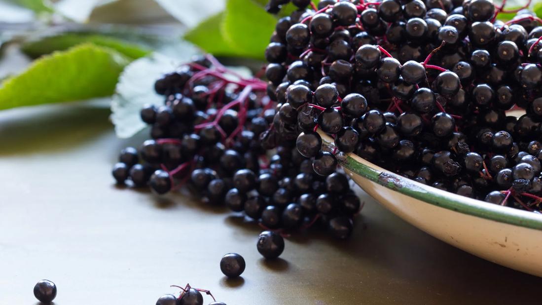 Elderberries spilling out of a bowl
