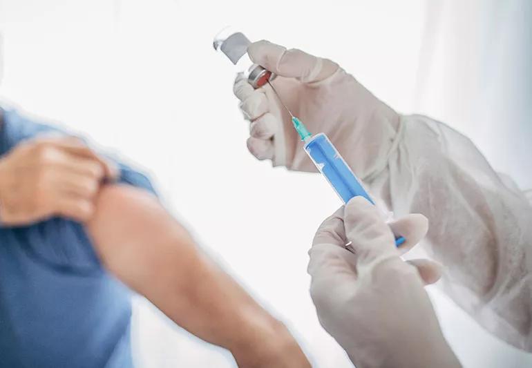 healthcare worker preparing covid vaccine