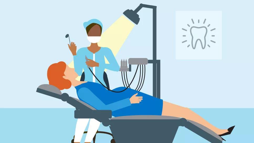 Pregnant patient lying in dentist chair during examination with dentist beside her