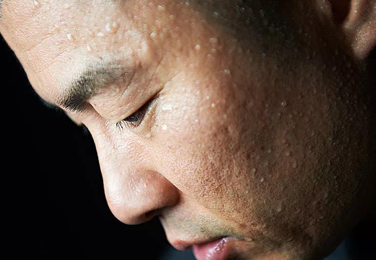 closeup of man's sweating face