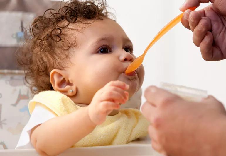 baby being fed baby food