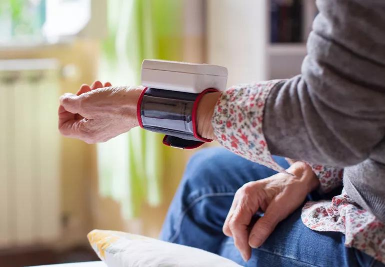 woman taking blood pressure reading at home