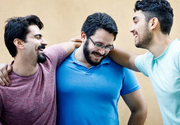 three friends with beards laughing
