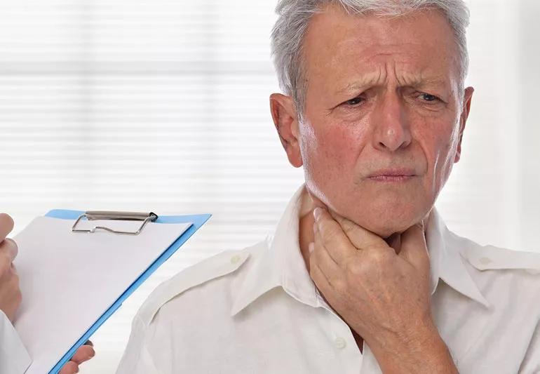 Older man at doctors office worried about lymph nodes in neck