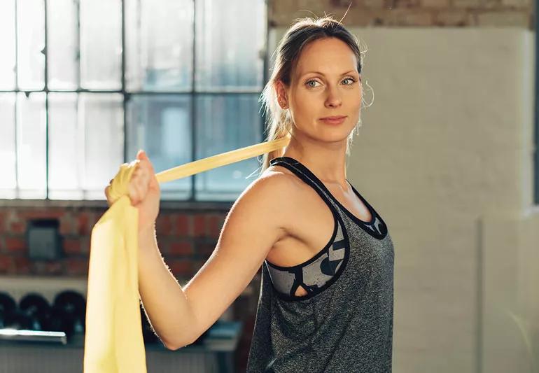 woman using stretchbands for upper body