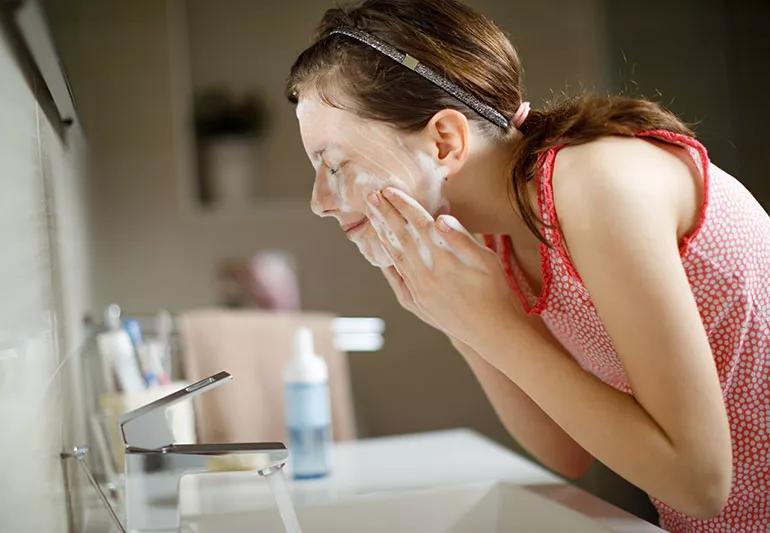 A person washing their face