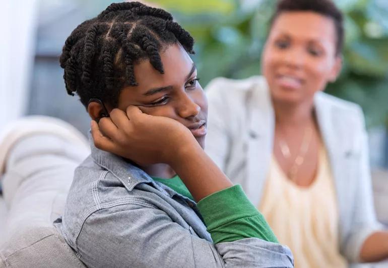 Teenager and parent having a talk