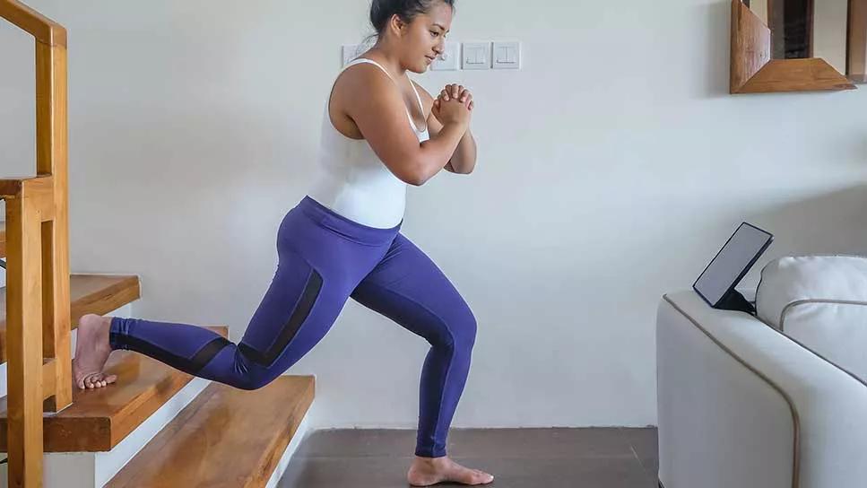 person doing stair lunges at home
