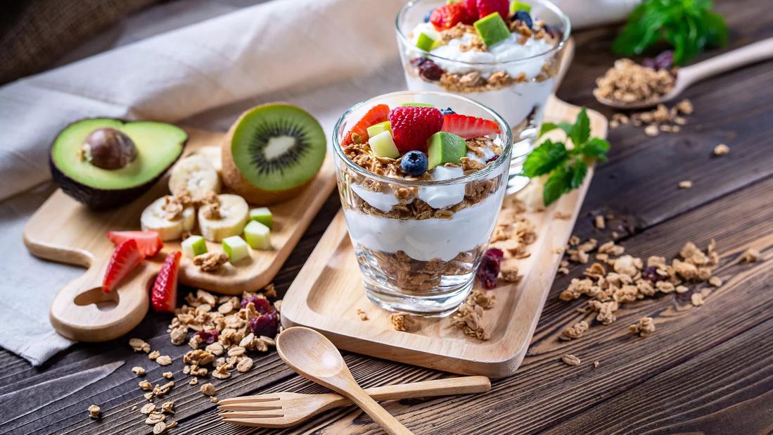 Yogurt, granola, fruit parfatis, with fruit on cutting boards