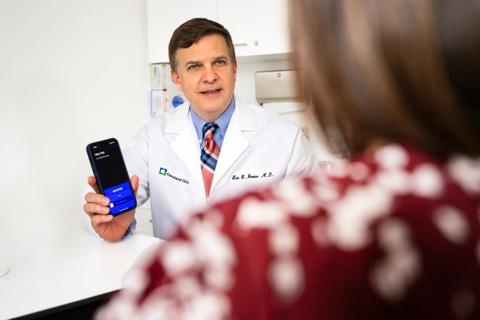 Physician showing patient the phone-based AI scribe