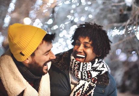 Friends laughing and spending time together outside in winter.