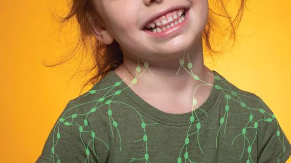 Smiling child in green shirt with superimposed outline of the lymphatic system