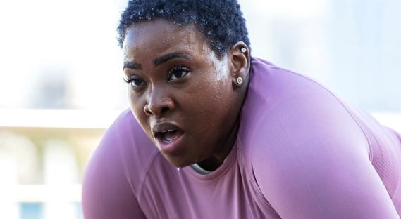 Person sweating, catching their breath during a workout
