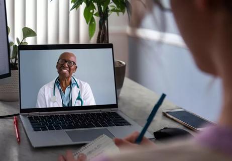 woman talking to doctor via computer