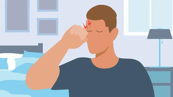 Person in bedroom, rubbing their eyes