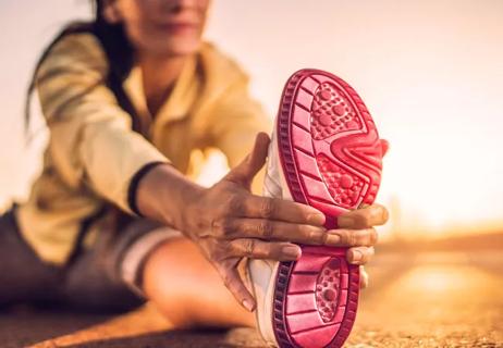 A woman stretches before exercising.