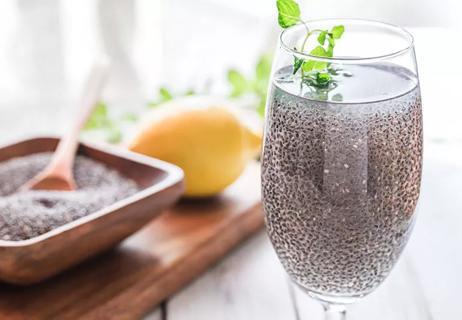 A glass of water with chia seeds in it